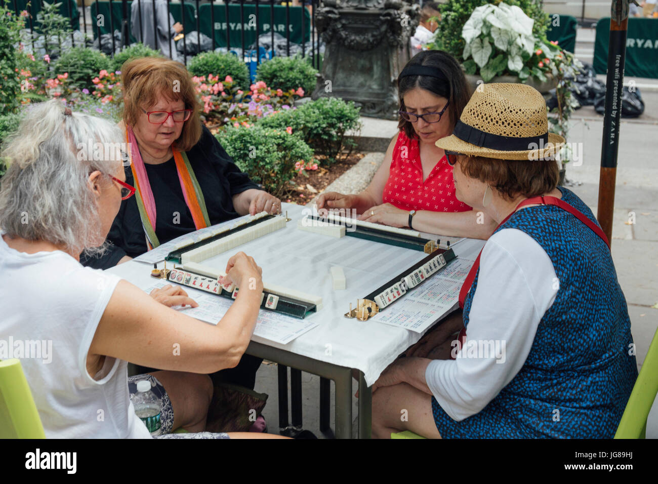 New York, USA. 3rd July, 2017. Hobbyists play Mah Jongg during the 'Mah Jongg Marathon' event at Bryant Park in New York City, the United States, on July 3, 2017. According to event organizer Linda Fisher, the event is organized to provide a place for Mah Jongg hobbyists to communicate with each other and promote the game to more people. Mah Jongg, originated from China, was introduced to the United States in the 1920s. Credit: Xu Keshuang/Xinhua/Alamy Live News Stock Photo
