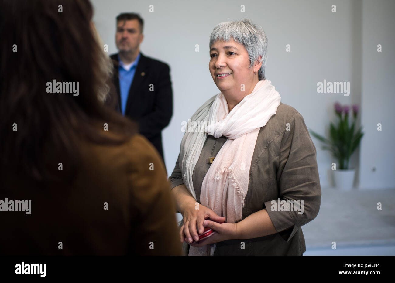 Seyran Ates, co-founder and idea provider of the liberal mosque, speaks to journalists during a visit of Cem Oezdemir, federal chairman of the Buendnis 90/Die Gruenen party, to the Ibn Rushd-Goethe Mosque in Berlin, Germany, 4 July 2017. The mosque founded in June 2017 does not have its own building, instead it uses a room in an attached building of the protestant St. Johannis church in the district of Moabit in Berlin. The new mosque offers a space for joint prayers for men and women as well as Sunnites, Schiites and Alevis. Photo: Bernd von Jutrczenka/dpa Stock Photo