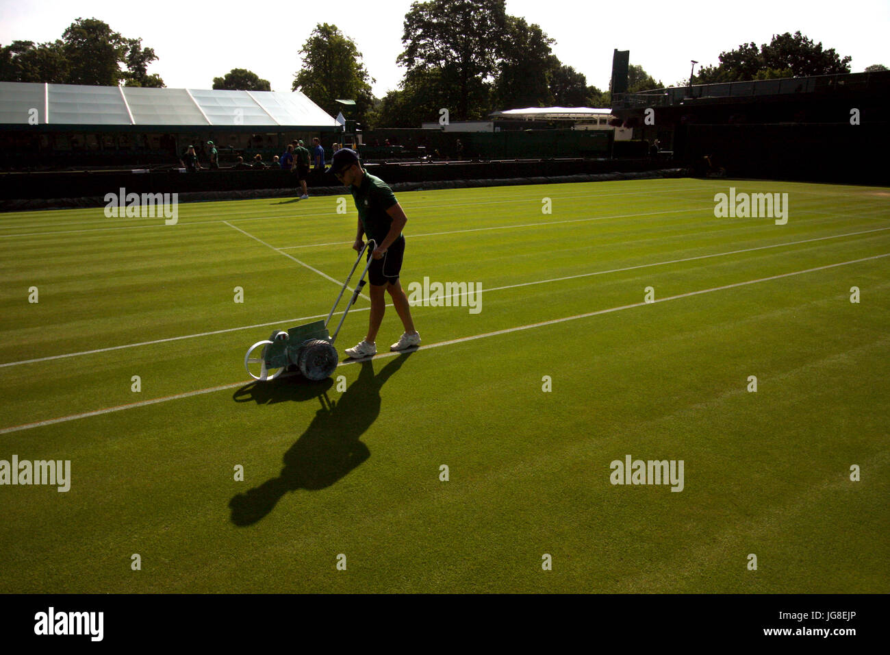 London, UK. 04th July, 2017. A bellboy chalks the line of one of the outside courts at the All England Lawn Tennis Club as preparation for day 2 of Wimbledon. Credit: Adam Stoltman/Alamy Live News Stock Photo