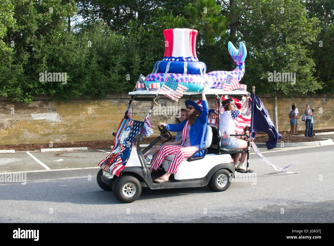 Sullivan's Island, South Carolina, USA. 4th July, 2017. A family rides along in a golf cart decorated in patriotic bunting during the annual Sullivan's Island Independence Day parade July 4, 2017 in Sullivan's Island, South Carolina. The tiny affluent sea island hosts a bicycle and golf cart parade through the historic village. Credit: Planetpix/Alamy Live News Stock Photo