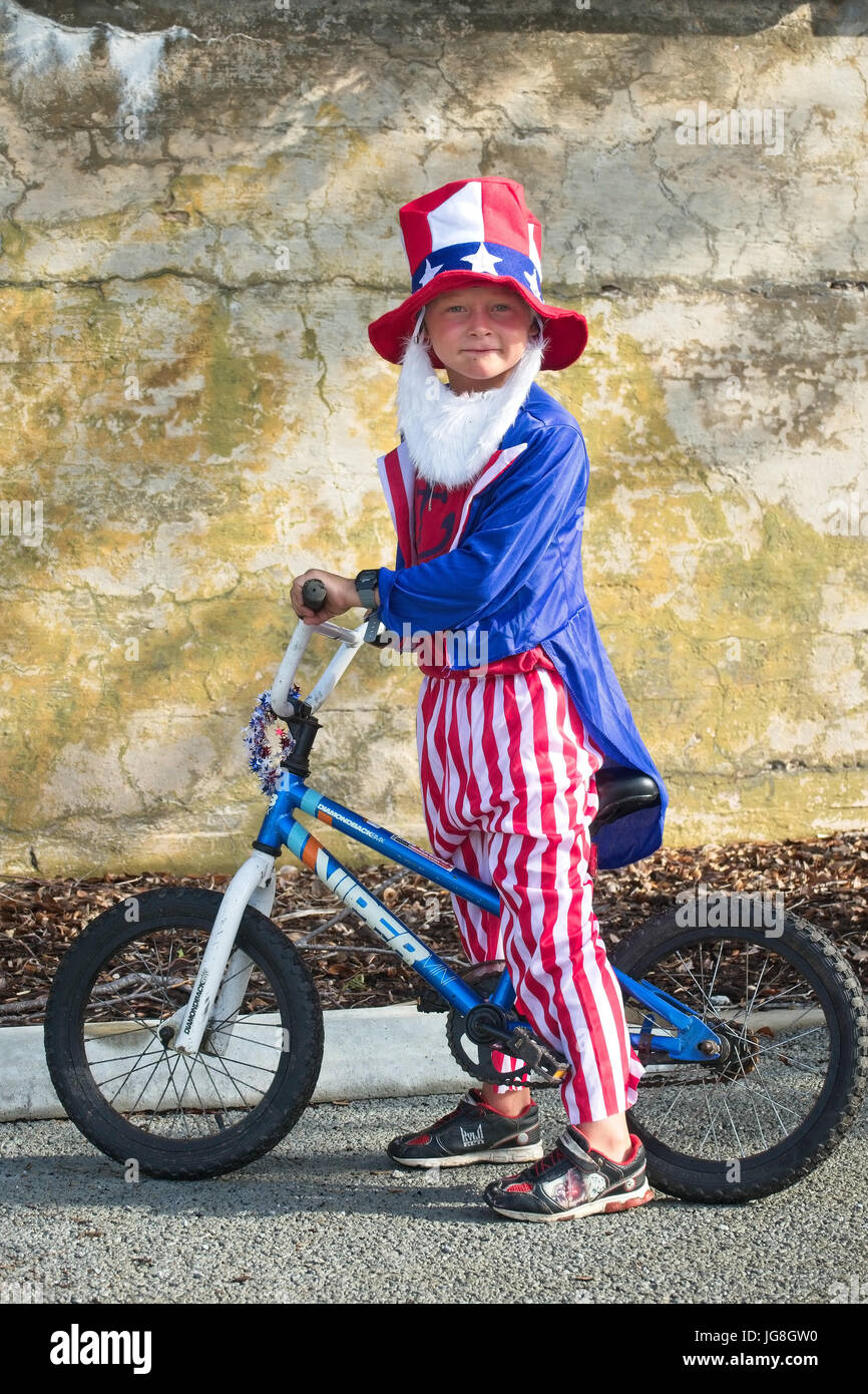 Sullivan's Island, South Carolina, USA. 4th July, 2017. A young boy dressed as Uncle Sam rides his bike during the annual Sullivan's Island Independence Day parade July 4, 2017 in Sullivan's Island, South Carolina. The tiny affluent sea island hosts a bicycle and golf cart parade through the historic village. Credit: Planetpix/Alamy Live News Stock Photo