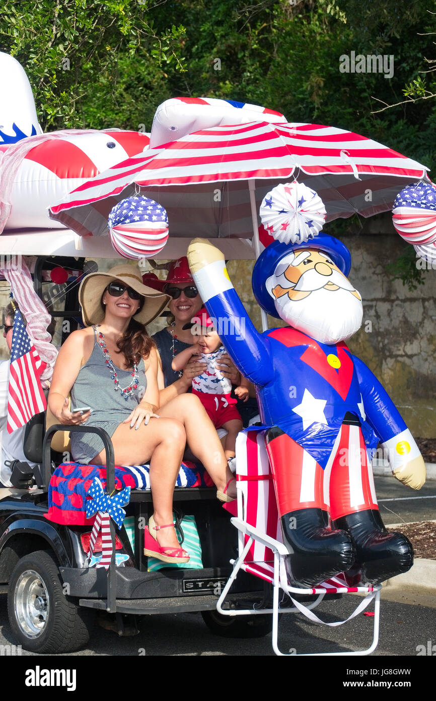 Sullivan's Island, South Carolina, USA. 4th July, 2017. A family rides along in a golf cart decorated in patriotic bunting during the annual Sullivan's Island Independence Day parade July 4, 2017 in Sullivan's Island, South Carolina. The tiny affluent sea island hosts a bicycle and golf cart parade through the historic village. Credit: Planetpix/Alamy Live News Stock Photo