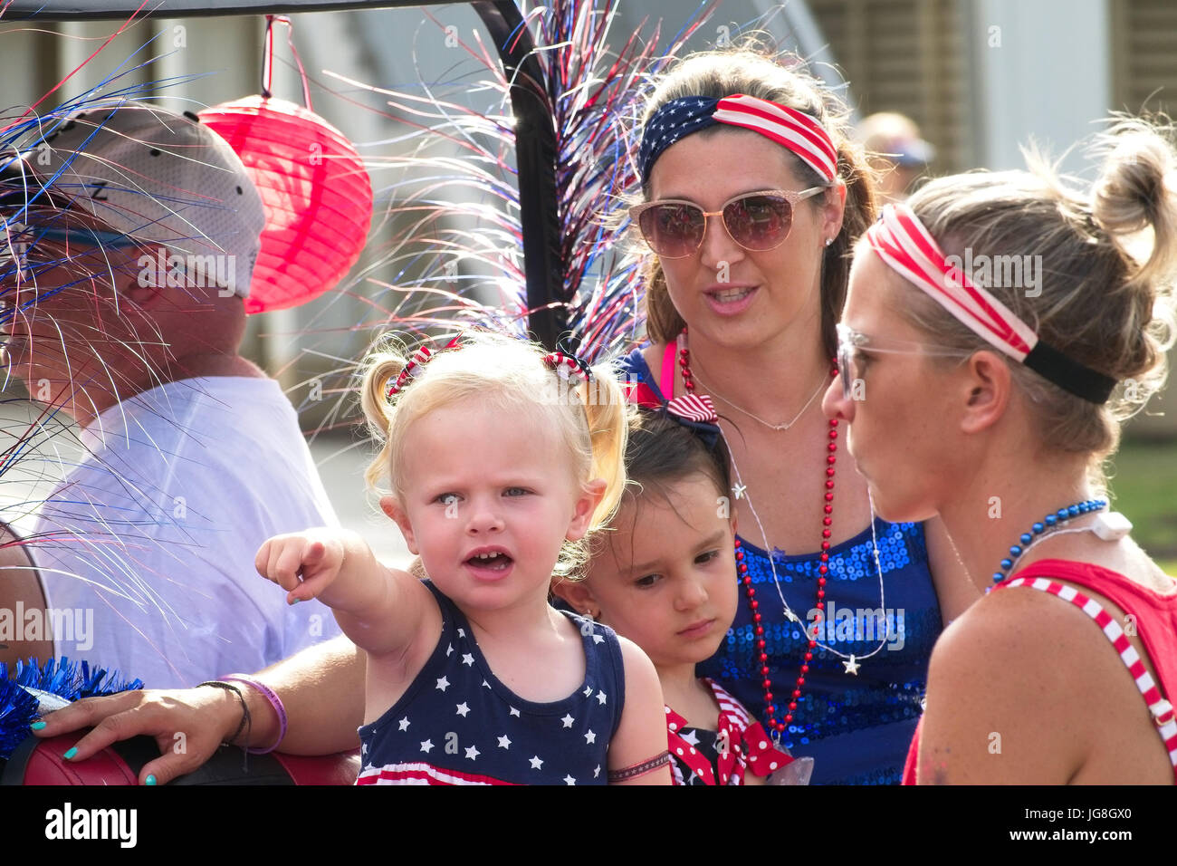 Sullivan's Island, South Carolina, USA. 4th July, 2017. A young family wearing patriotic costume during the annual Sullivan's Island Independence Day parade July 4, 2017 in Sullivan's Island, South Carolina. The tiny affluent sea island hosts a bicycle and golf cart parade through the historic village. Credit: Planetpix/Alamy Live News Stock Photo