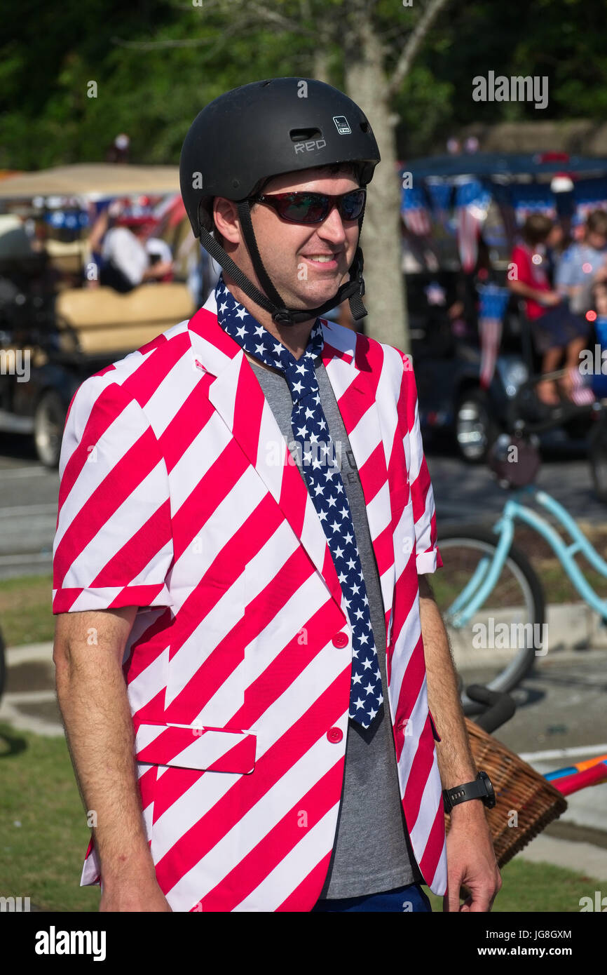 Sullivan's Island, South Carolina, USA. 4th July, 2017. A man wearing a red, white and blue suit prepares to join the annual Sullivan's Island Independence Day parade July 4, 2017 in Sullivan's Island, South Carolina. The tiny affluent sea island hosts a bicycle and golf cart parade through the historic village. Credit: Planetpix/Alamy Live News Stock Photo