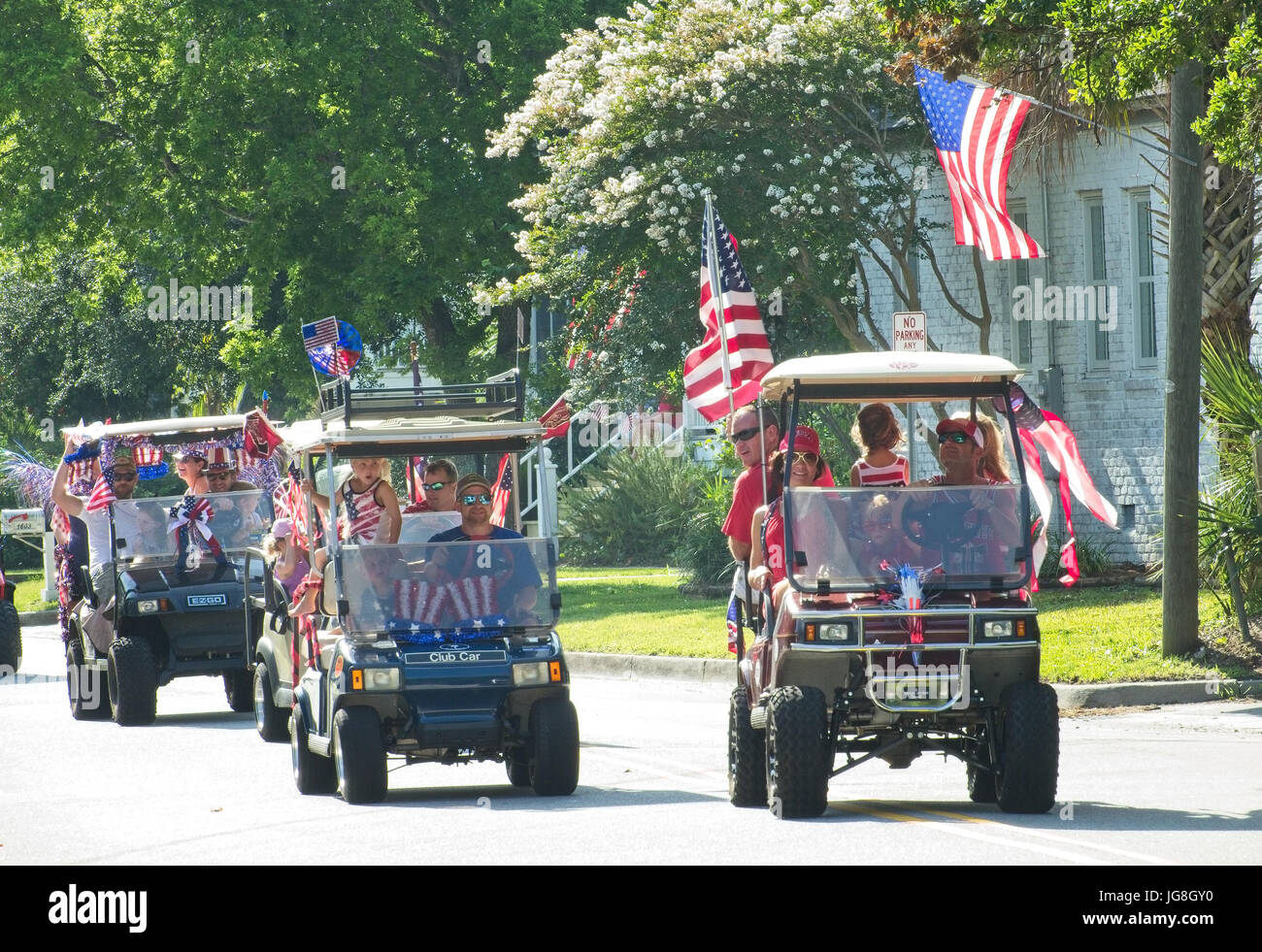 Sullivan's Island, South Carolina, USA. 4th July, 2017. Families ride decorated golf cart during the annual Sullivan's Island Independence Day parade July 4, 2017 in Sullivan's Island, South Carolina. The tiny affluent sea island hosts a bicycle and golf cart parade through the historic village. Credit: Planetpix/Alamy Live News Stock Photo