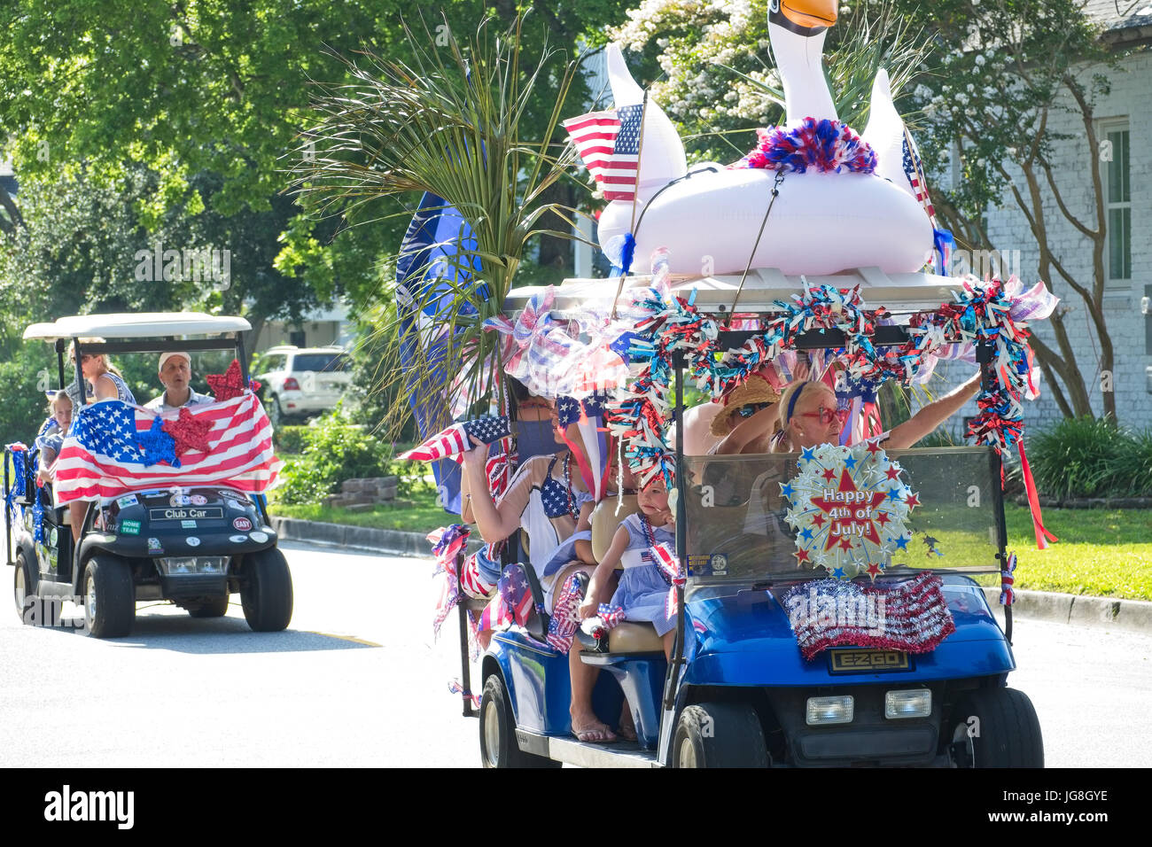 Sullivan's Island, South Carolina, USA. 4th July, 2017. Families ride decorated golf cart during the annual Sullivan's Island Independence Day parade July 4, 2017 in Sullivan's Island, South Carolina. The tiny affluent sea island hosts a bicycle and golf cart parade through the historic village. Credit: Planetpix/Alamy Live News Stock Photo