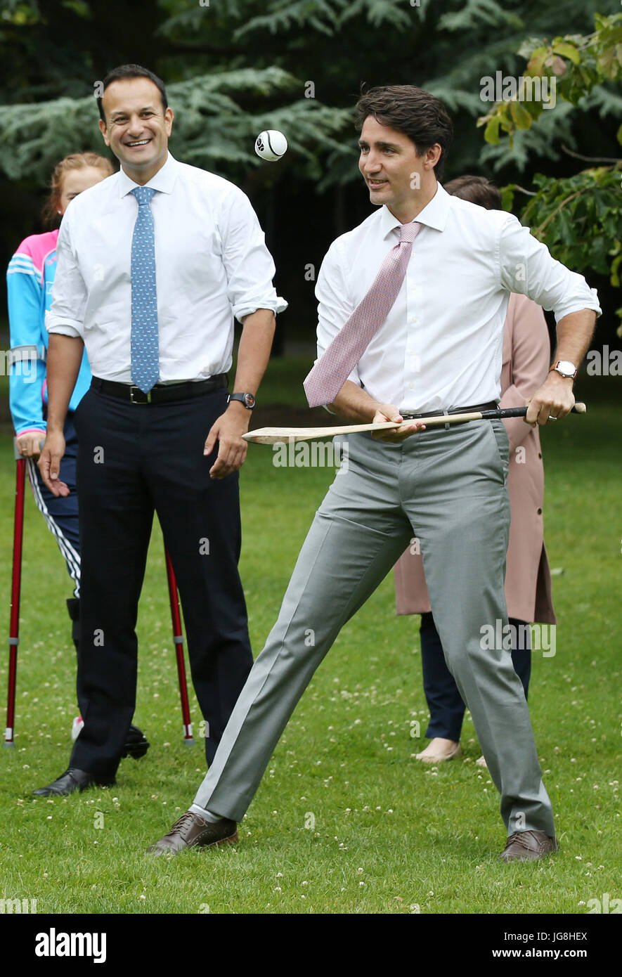 Ireland. 4th July, 2017. Official Visit to Ireland - Prime Minister of Canada Justin Trudeau. Taoiseach and Fine Gael leader Leo Varadkar TD watches as Prime Minister of Canada Justin Trudeau trys out Irelands national sport with a hurley and ball in Farmleigh, Dublin this morning. The Prime Minister of Canada Justin Trudeau is on an Official Visit to Ireland. Hurling which is played with 15 men on each side, is believed to be the fasted sport in the world. Photo: Sam Boal/Rollingnews.ie /Alamy Live News Stock Photo