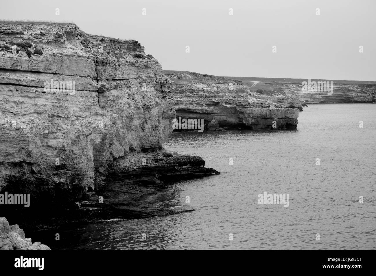 Beautiful rocky shore from the sea. Black and white photography Stock ...