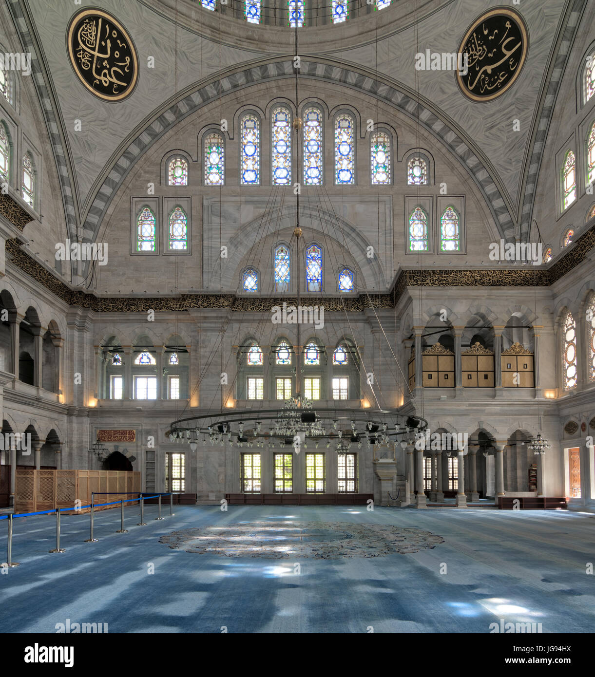 Interior of Nuruosmaniye Mosque, an Ottoman Baroque style mosque built in 1755, with a huge arches & many colored stained glass windows located in She Stock Photo