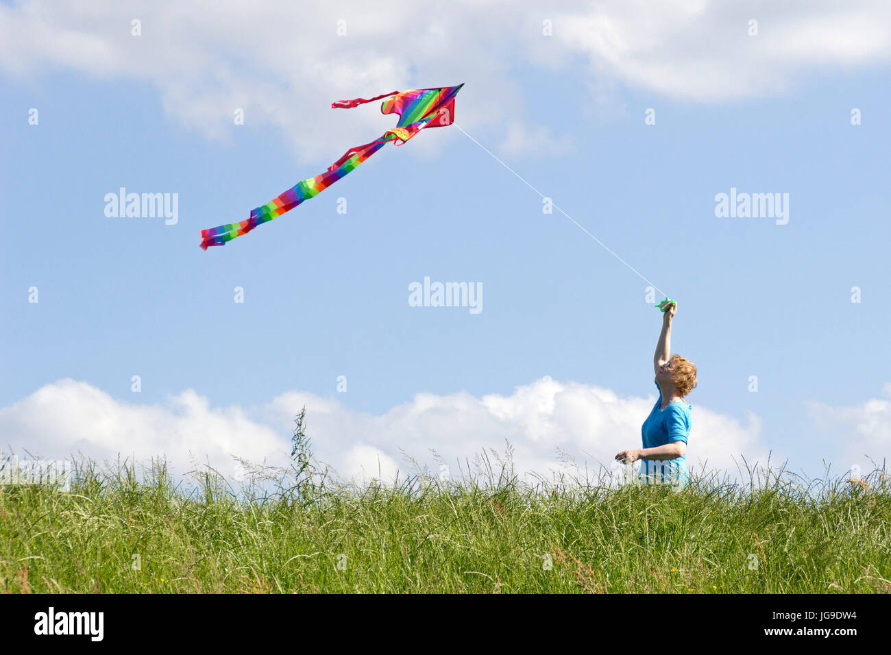 woman flying kite, Bleckede, Lower Saxony, Germany Stock Photo