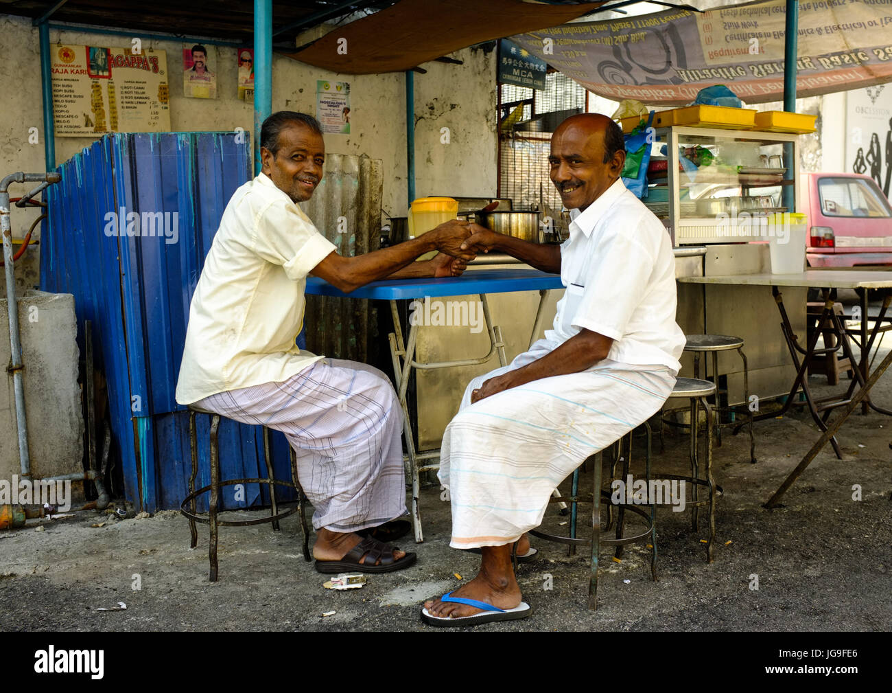Two Indian men shake hands in Little India, Georgetown, Penang, Malaysia Stock Photo