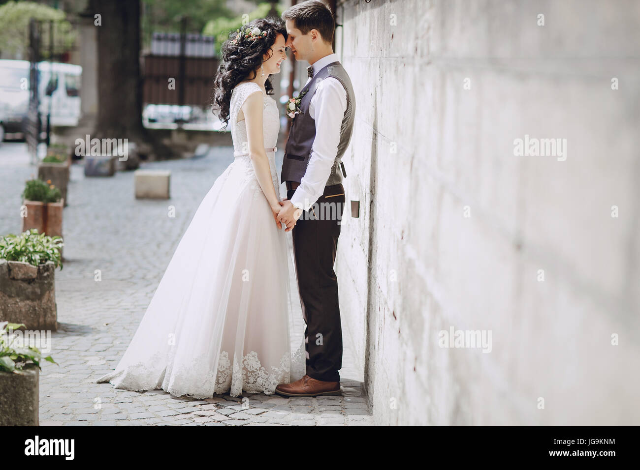 bride and groom walking in old city Stock Photo - Alamy