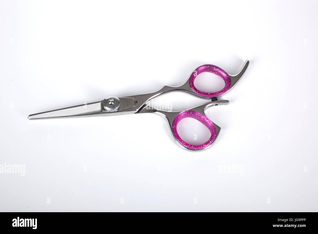 Professional haircutting scissors isolated on white background. Silver metal, stainless steel scissors. Stock Photo