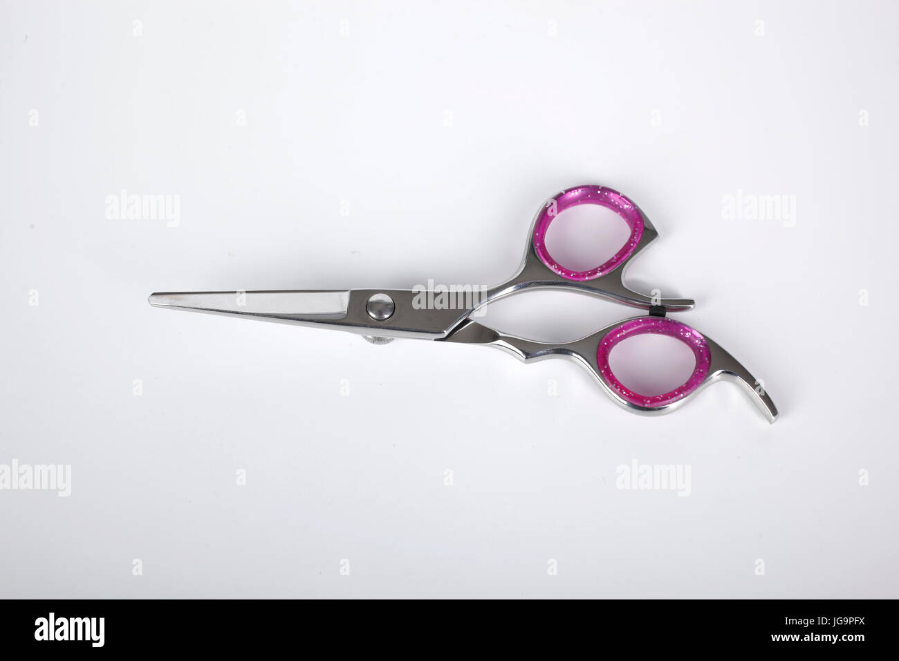 Professional haircutting scissors isolated on white background. Silver metal, stainless steel scissors. Stock Photo