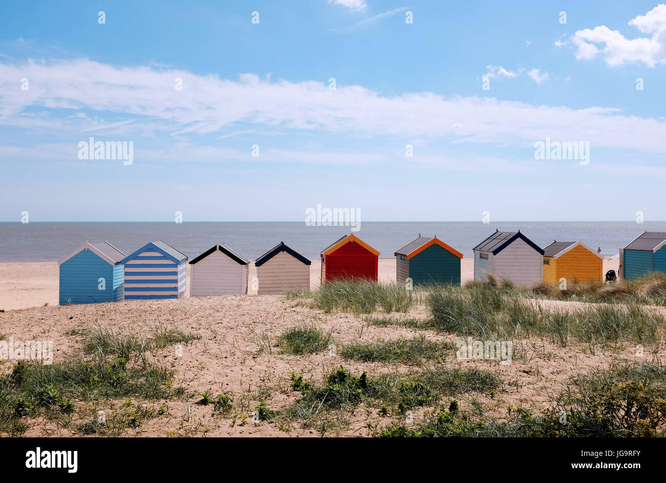 Southwold Suffolk UK June 2017 - Beach huts on the seafront with blue sky Photograph taken by Simon Dack Stock Photo