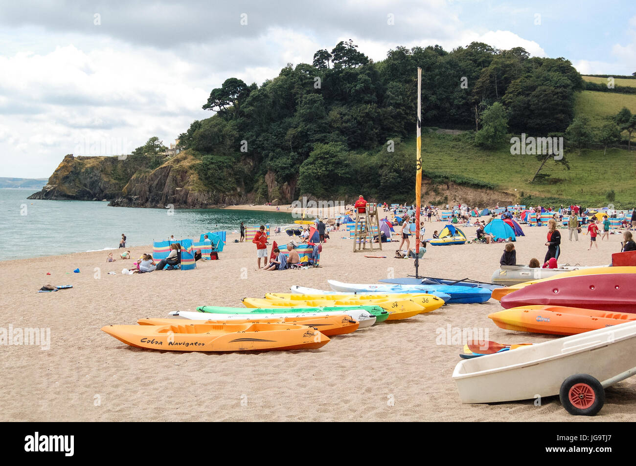 Boats and canoes on Blackpool Sands beach at Dartmouth in South Deon, UK. Stock Photo