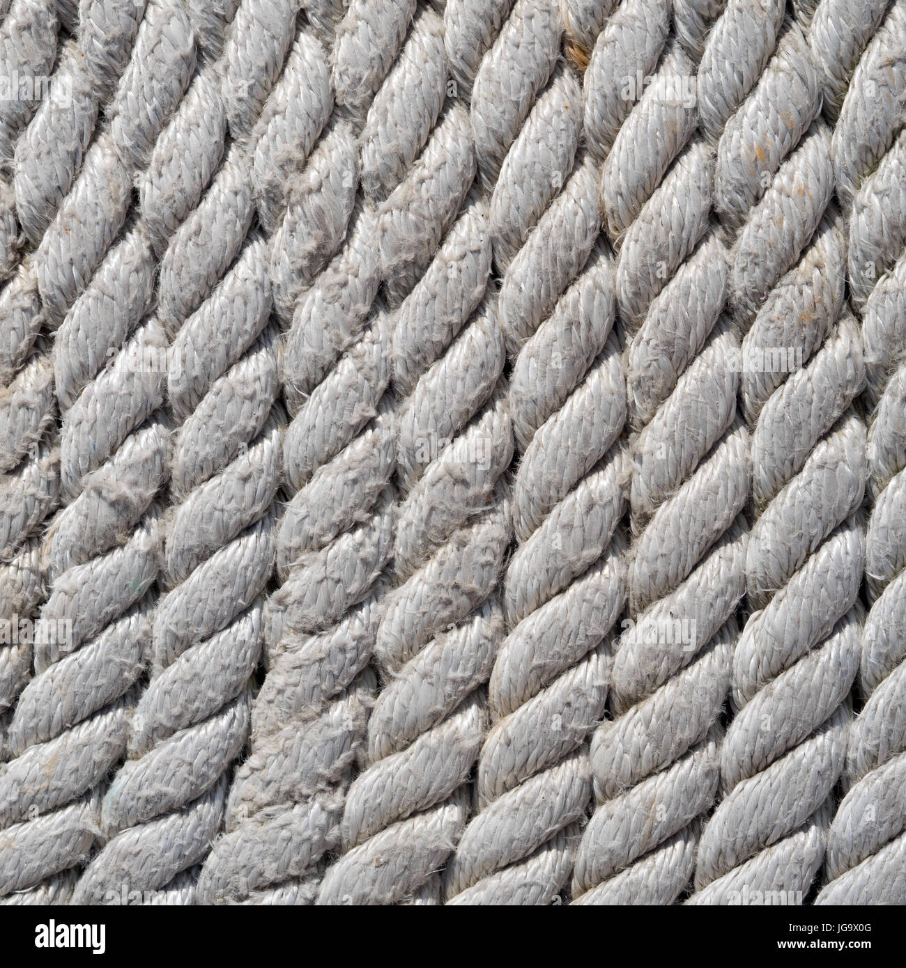 Tightly coiled fishing rope close up detail. Stock Photo