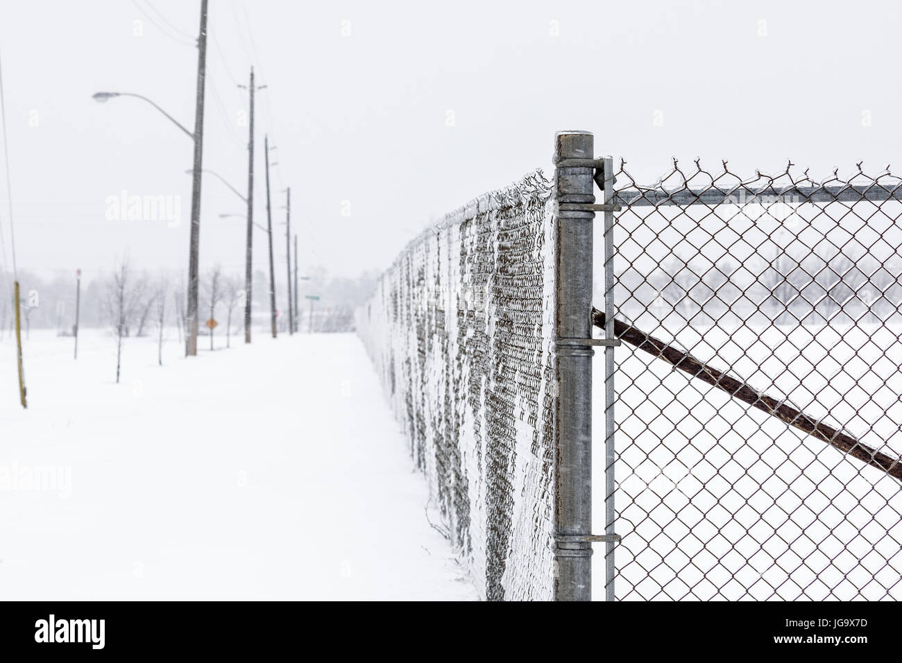 Chain-link fence covered with snow, Thunder Bay, Ontario, Canada. Stock Photo