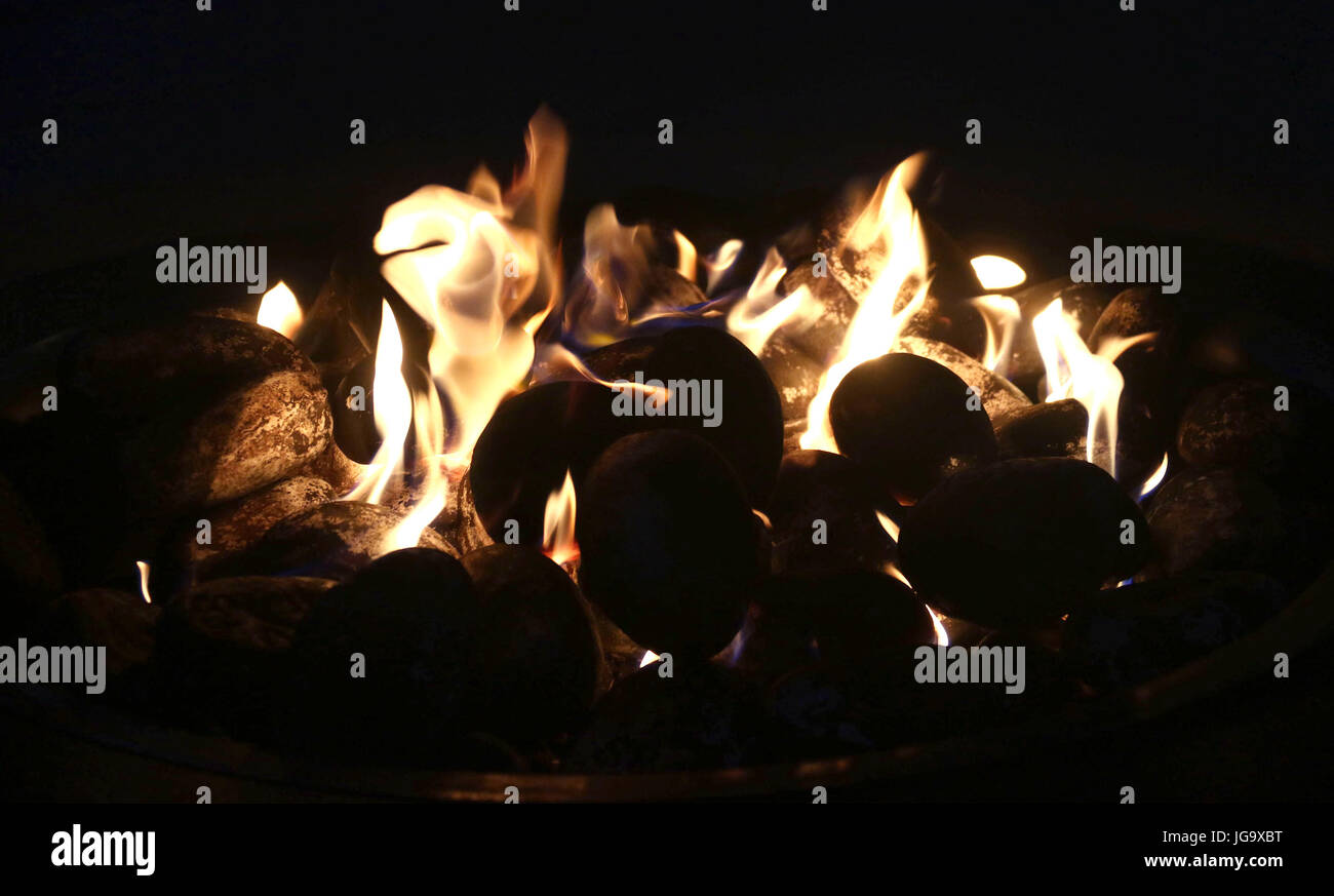 Glowing fire pit in the evening Stock Photo