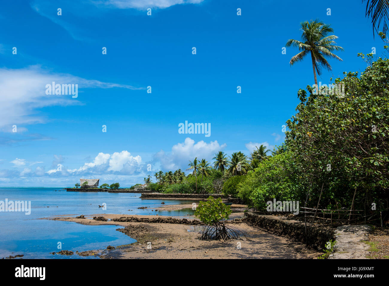 Traditional house with stone money in front, Island of Yap, Micronesia ...