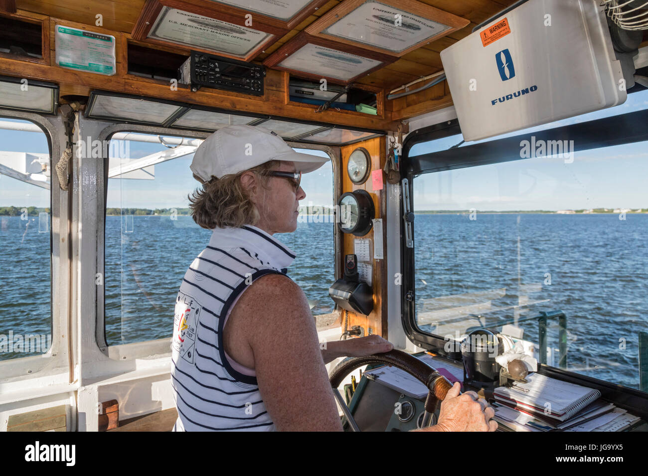 Oxford, Maryland - Marcia LoVerdi pilots the Bellevue-Oxford car ferry across the Tred Avon River near the Chesapeake Bay. LoVerdi has captained the f Stock Photo