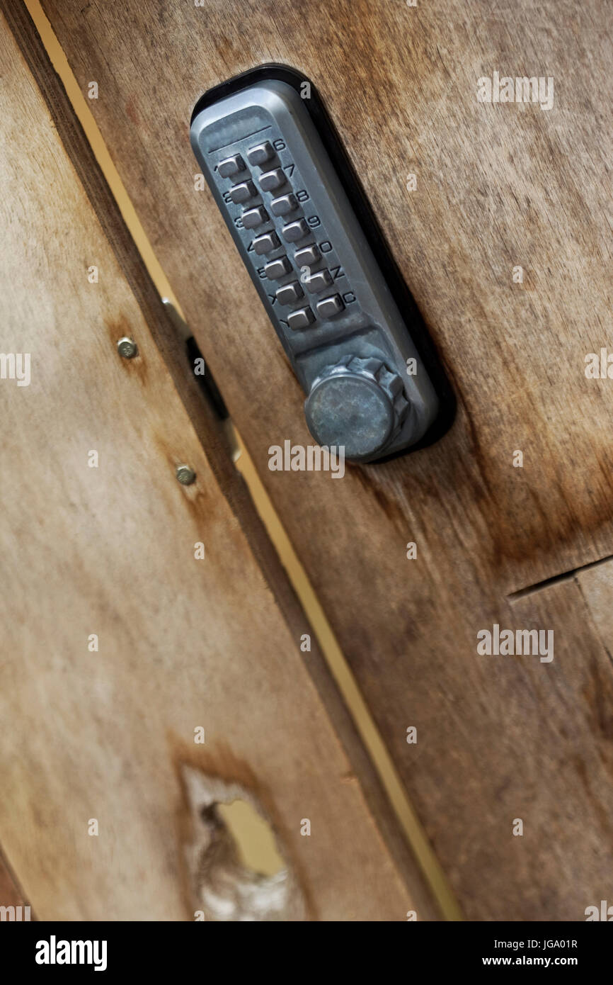 Digital code on a weathered wooden door Stock Photo - Alamy