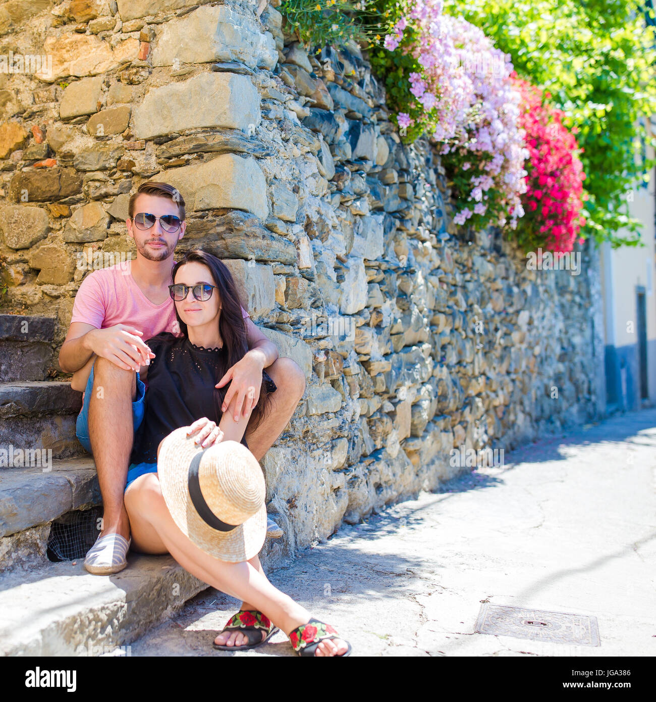 Young tourist couple traveling on european holidays outdoors in italian vacation in Cinque Terre Stock Photo