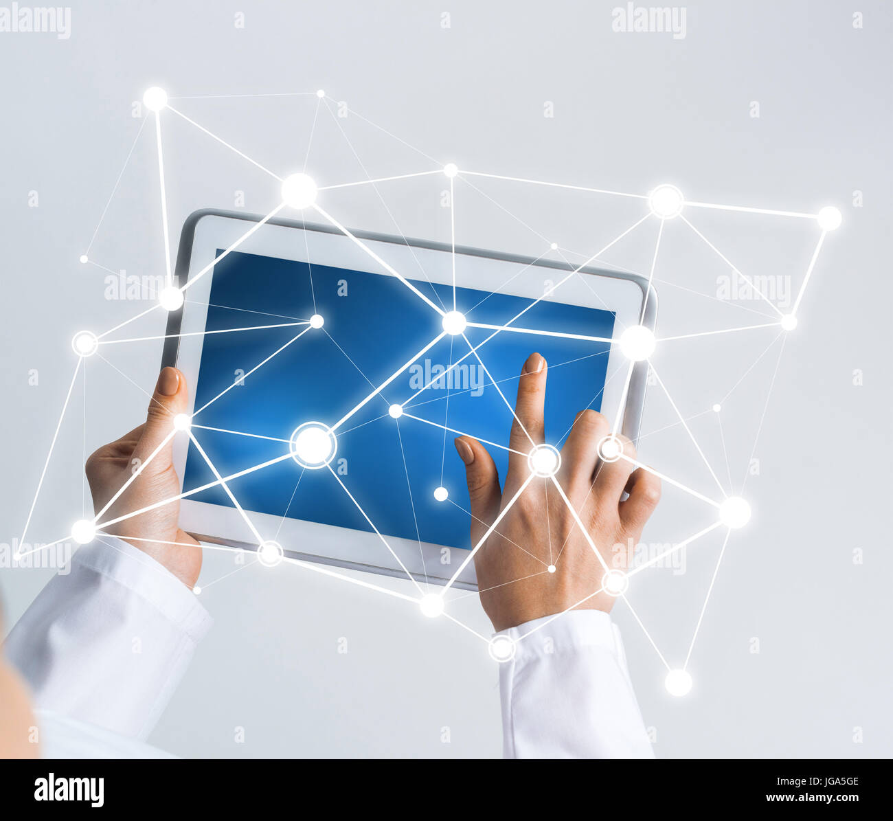 Tablet pc device with connection lines on screen in hands of doctor ...
