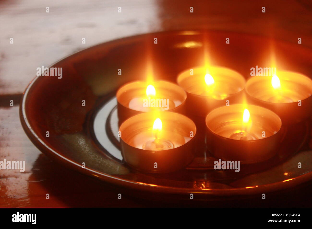 Holiday candles burning on table. funeral horizontal background Stock Photo