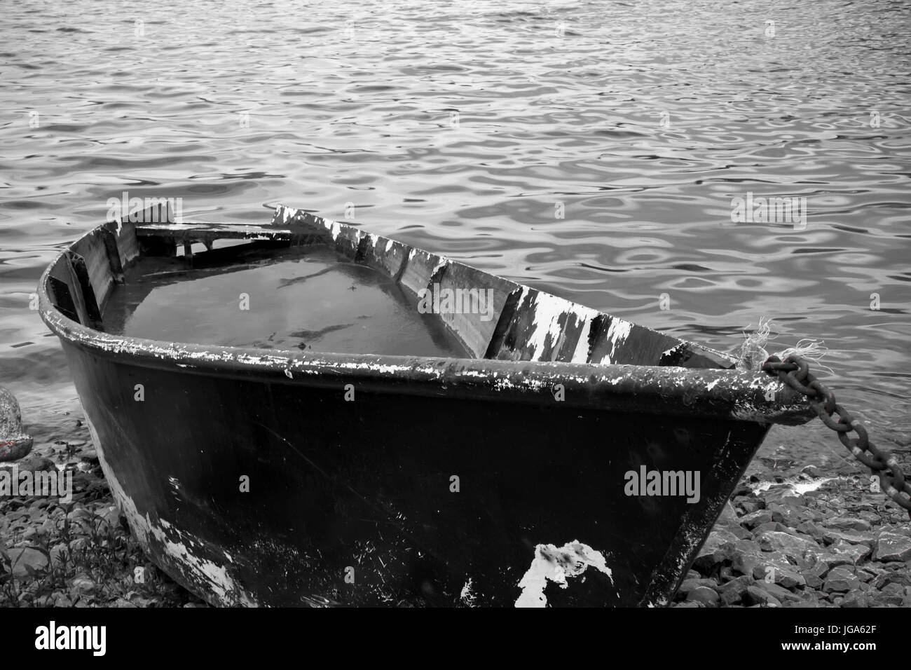 Fishing boat full of water on the shore Stock Photo Alamy
