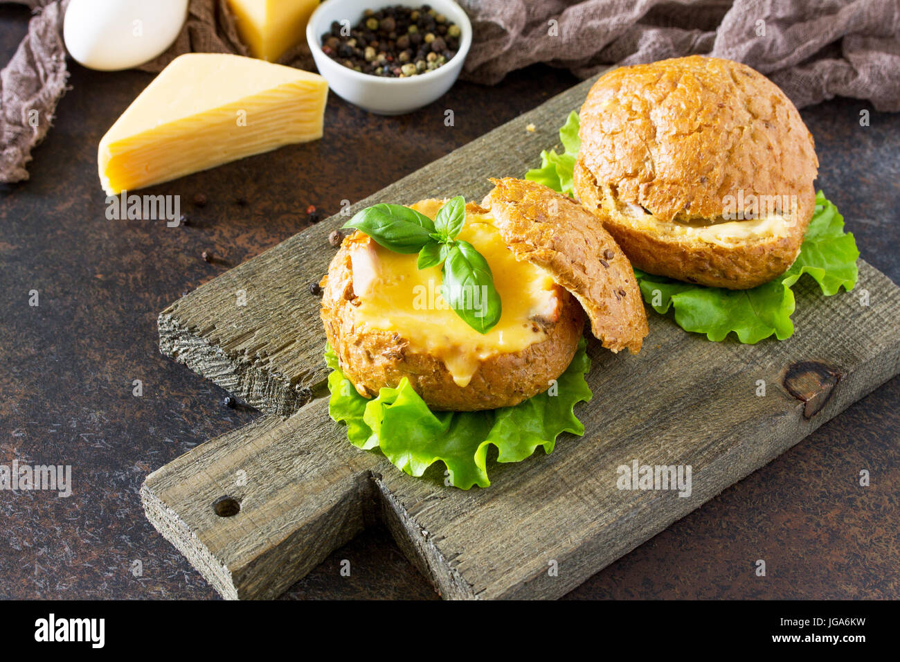 Scrambled eggs with ham, baked in a bun cheese and green salad. French