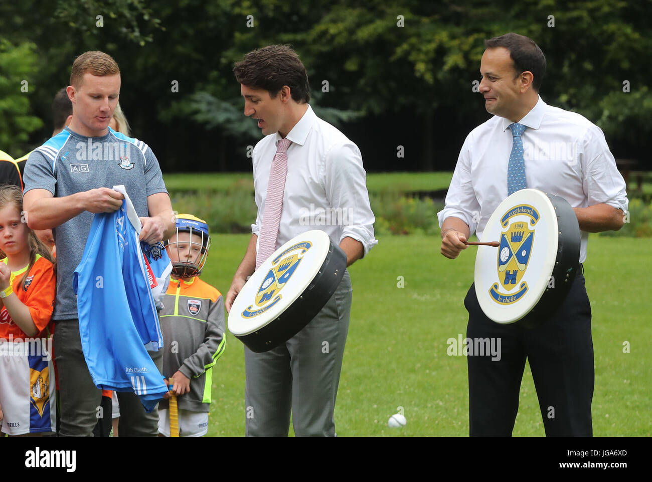 Canadian Prime Minister Justin Trudeau (centre) is presented with an Irish football shirt by Dublin GAA footballer Ciaran Kilkenny, after receiving a Bodhran (Irish drum) with Irish Taoiseach Leo Varadkar, after they held a press conference at Farmleigh House in Dublin. Stock Photo