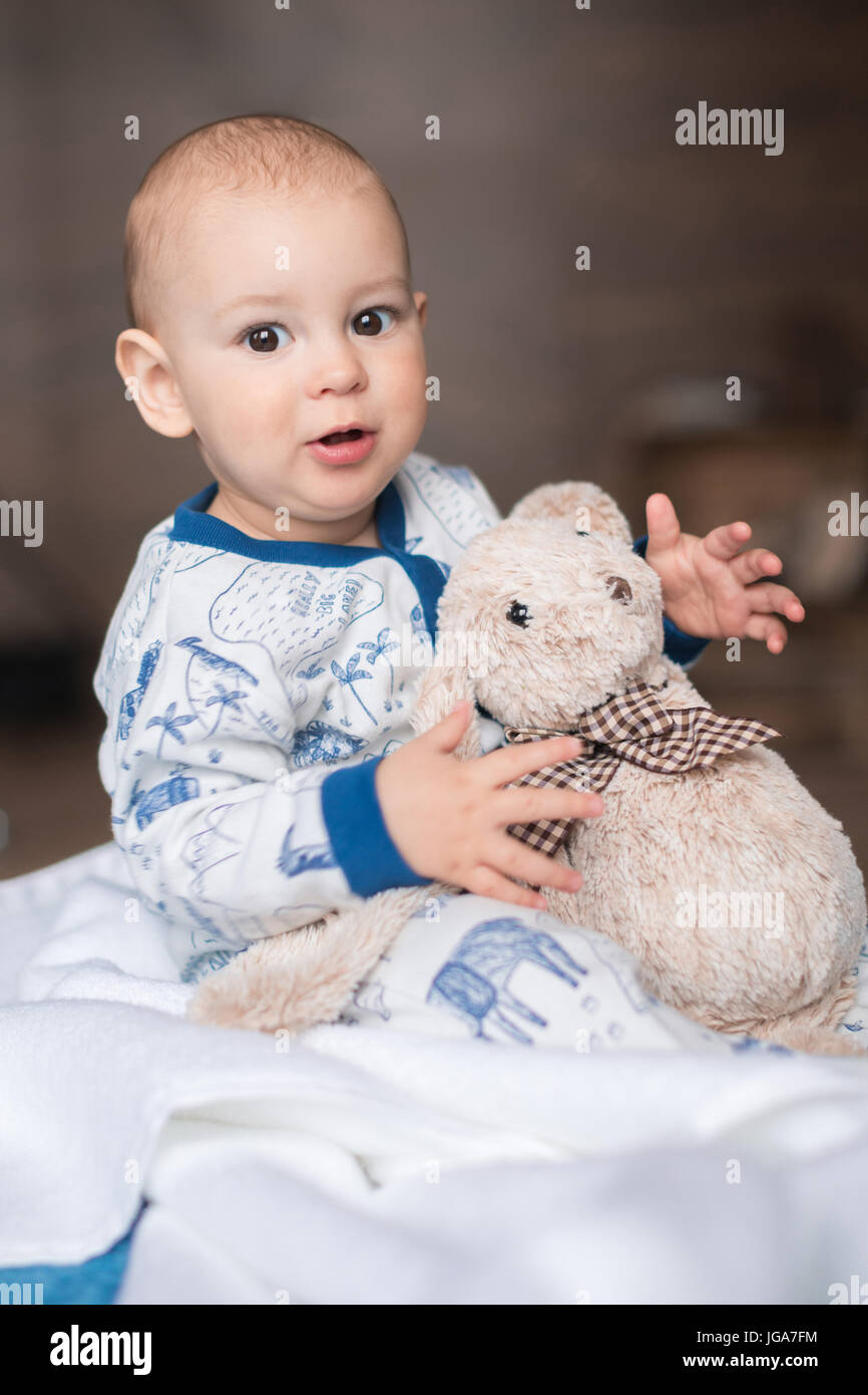 adorable little boy playing with teddy bear toy Stock Photo - Alamy
