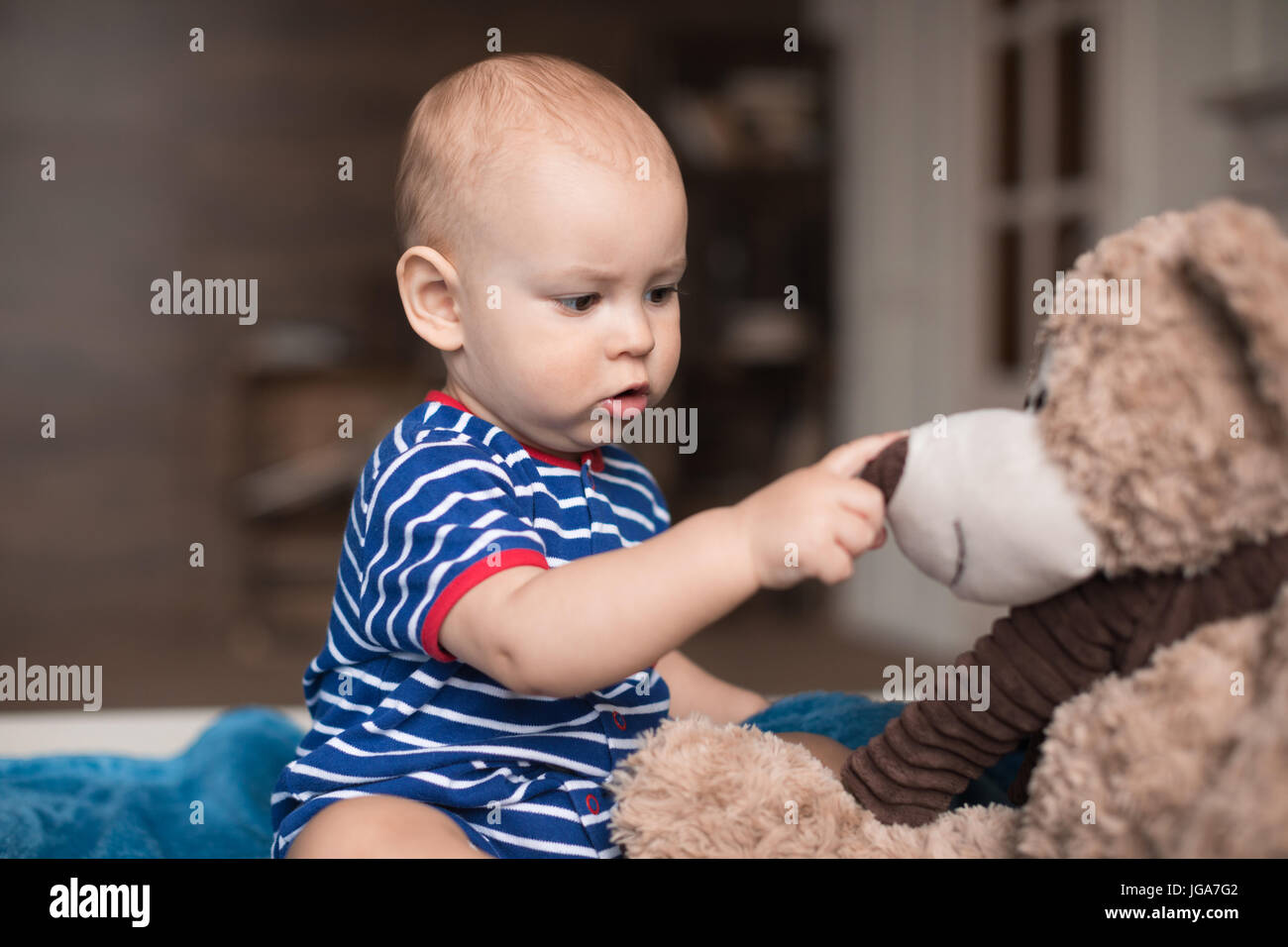 adorable little boy playing with teddy bear toy Stock Photo - Alamy