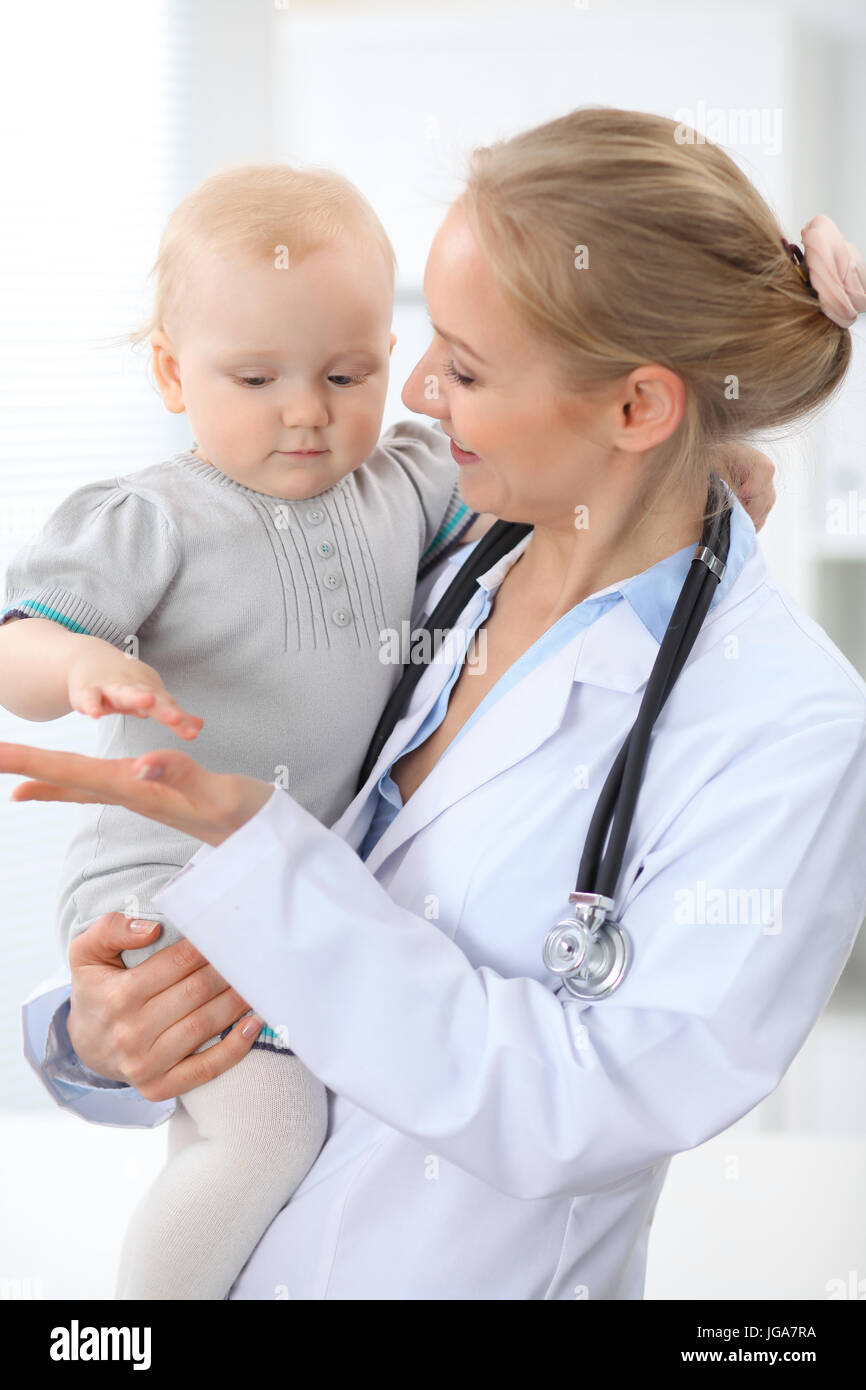 Pediatrician is taking care of patient in hospital. Female doctor holds