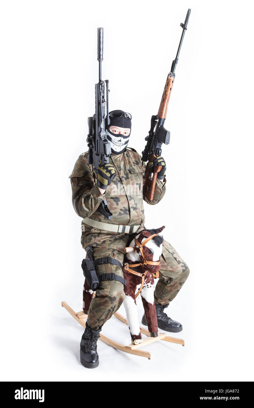 Hilarious anti terrorist with two guns sitting on rocking-horse isolated on white background Stock Photo