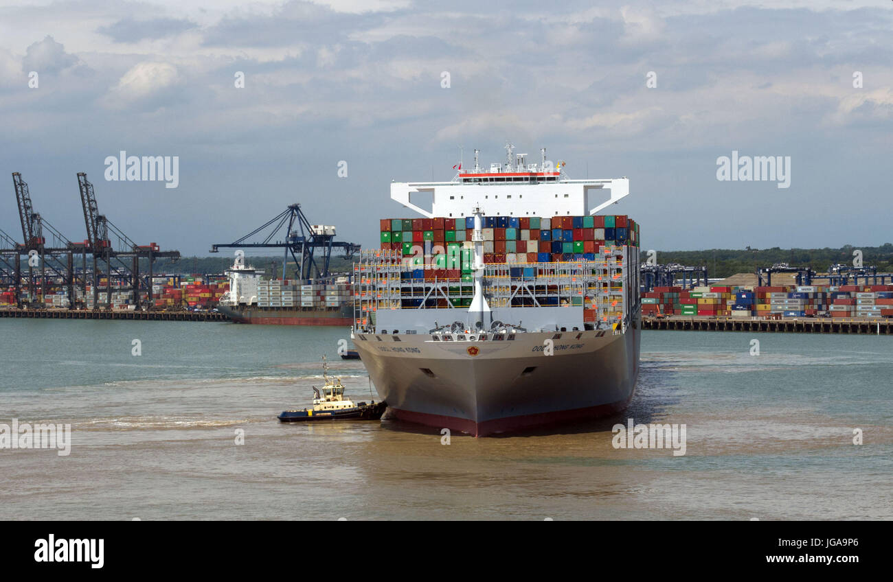 OOCL Hong Kong, the world's largest container ship, which can carry 21,413 twenty foot containers and is 1,311 feet long, docks in Felixstowe on its last stop on its maiden voyage to Europe before returning to the Far East as part of an estimated 77-day round trip. Stock Photo
