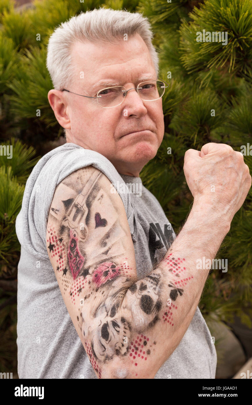 Senior man Showing off His New Tattoos, USA Stock Photo