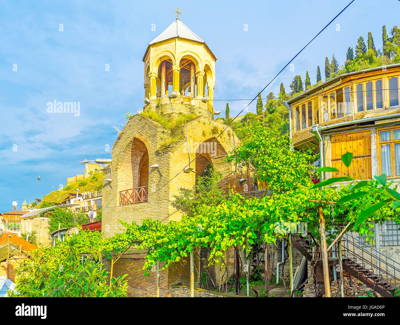 The bell tower of Upper Bethlehem church, surrounded by grape vines, located in historic Kldisubani neighborhood, at the foot of Narikala fortress, Tb Stock Photo