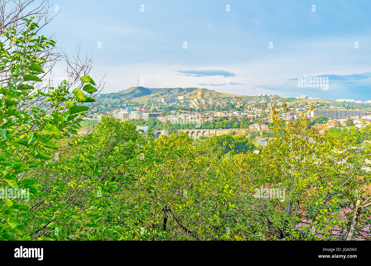 The old hilly Kldisubani neighborhood boasts lush fruit gardens, also here are many perfect viewpoints, overlooking the city - Sameba Cathedral, risin Stock Photo