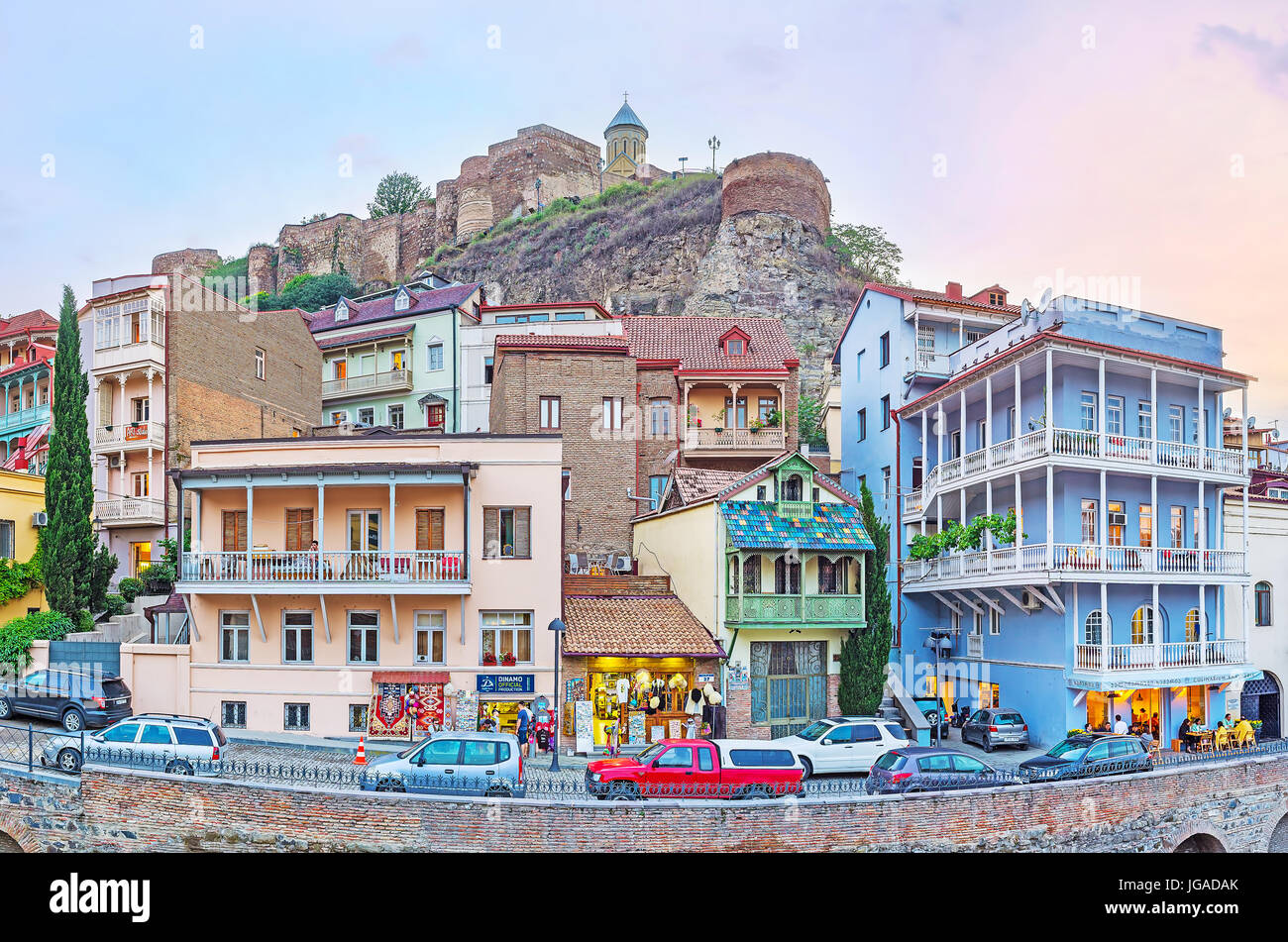 TBILISI, GEORGIA - JUNE 5, 2016: The renovated edifices at the foot of Sololaki hill, topped with Narikala fortress with numerous souvenir stores, caf Stock Photo
