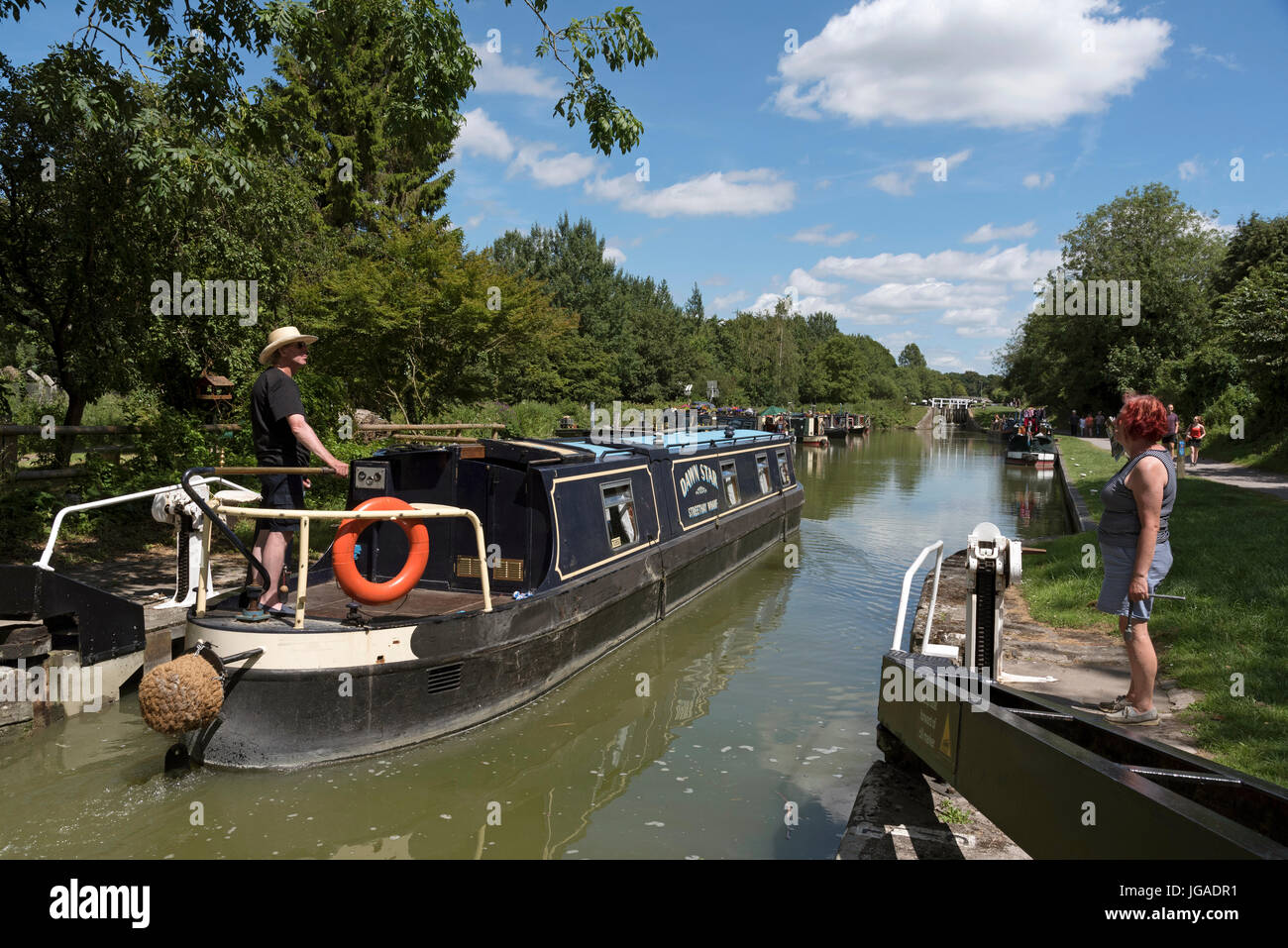 Holiday rental canalboat exiting a lock  on the Kennet & Avon Canal close to Devizes in Wiltshire England UK. Stock Photo
