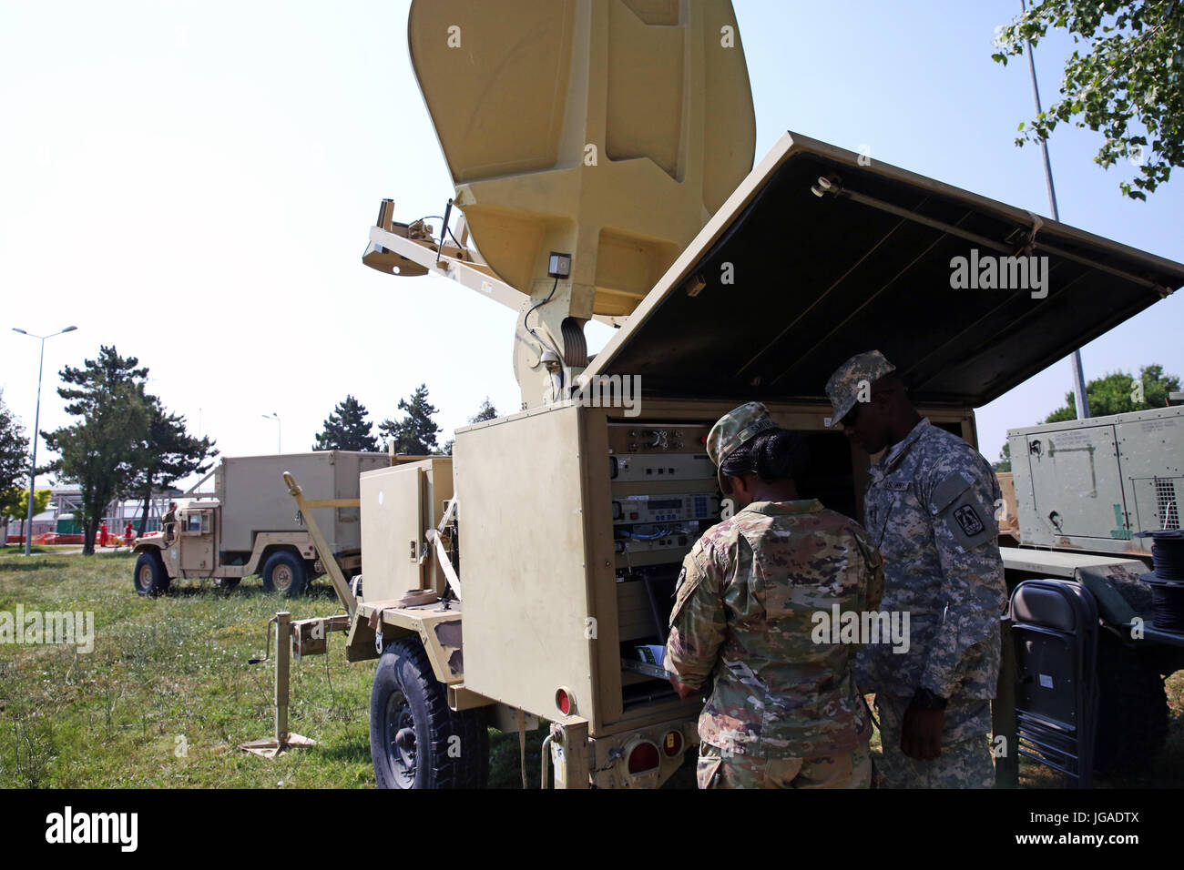 U.S. Army Spc. Kendra Smith and Spc. Antwan Campbell, both assigned to Charlie Company, 86th Expeditionary Signal Battalion, 11th Signal Brigade, work to establish a satellite link June 29, 2017 at Mihail Kogalniceanu Air Base, Romania. The 86th Expeditionary Signal Bn. from Fort Bliss, Texas is augmenting 2nd Theater Signal Brigade with additional tactical signal assets and capability for exercise Saber Guardian 17, a U.S. Army Europe-led, multinational exercise, taking place in Bulgaria, Hungary and Romania July 11-20, 2017. (U.S. Army photo by William B. King) Stock Photo