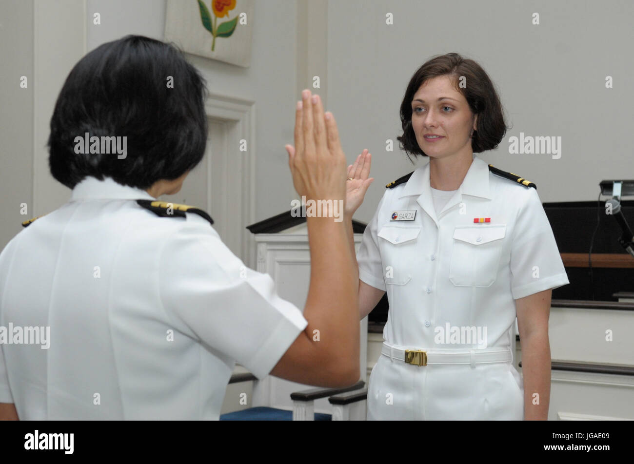 CORPUS CHRISTI, Texas (June 30, 2017) Naval Health Clinic (NHC) Corpus Christi Senior Nurse Executive (SNE), Capt. Kimberly Taylor, administers the oath to Lt. Brittany Garza, family nurse practitioner (FNP), during her promotion ceremony at the Naval Air Station Corpus Christi Protestant Chapel June 30. (U.S. Navy photo by Bill W. Love/RELEASED) 170630-N-KF478-001 Stock Photo