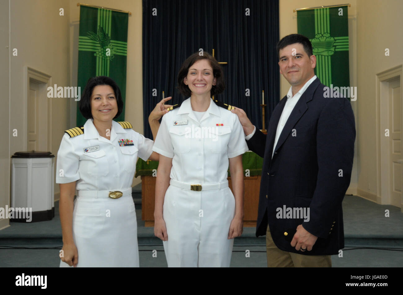 CORPUS CHRISTI, Texas (June 30, 2017) Naval Health Clinic (NHC) Corpus Christi Senior Nurse Executive (SNE), Capt. Kimberly Taylor, and Family Nurse Practitioner (FNP) Lt. Brittany Garza with her husband, Jose Garza, during her promotion ceremony at the Naval Air Station Corpus Christi Protestant Chapel June 30. (U.S. Navy photo by Bill W. Love/RELEASED) 170630-N-KF478-012 Stock Photo