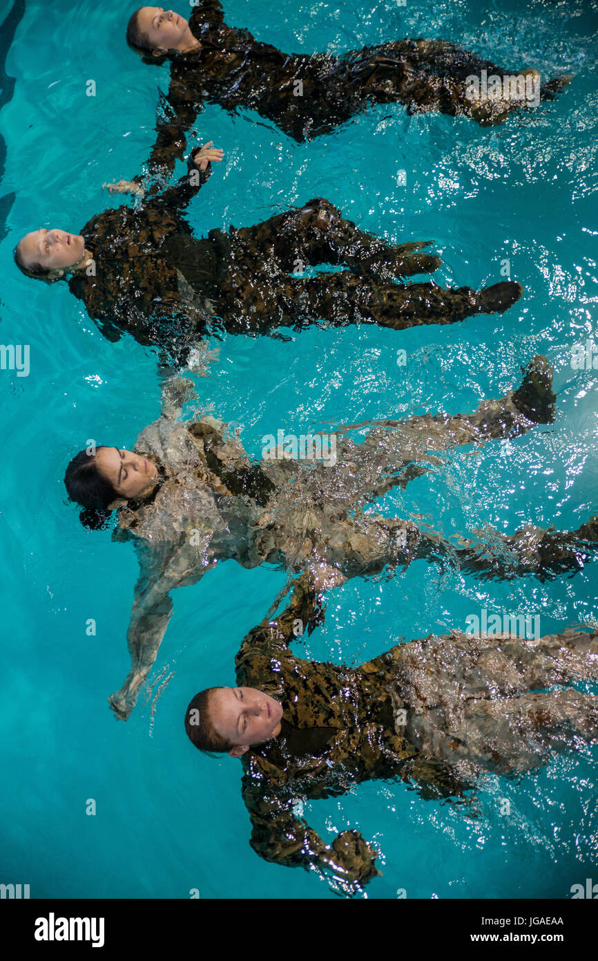 U.S. Marine Corps recruits with Oscar Company, 4th Recruit Training Battalion, tread water during basic water survival training June 26, 2017, on Parris Island, S.C. Recruits must pass water survival training in order to graduate. Oscar Company is scheduled to graduate Aug. 25, 2017. Parris Island has been the site of Marine Corps recruit training since Nov. 1, 1915. Today, approximately 19,000 recruits come to Parris Island annually for the chance to become United States Marines by enduring 12 weeks of rigorous, transformative training. Parris Island is home to entry-level enlisted training f Stock Photo