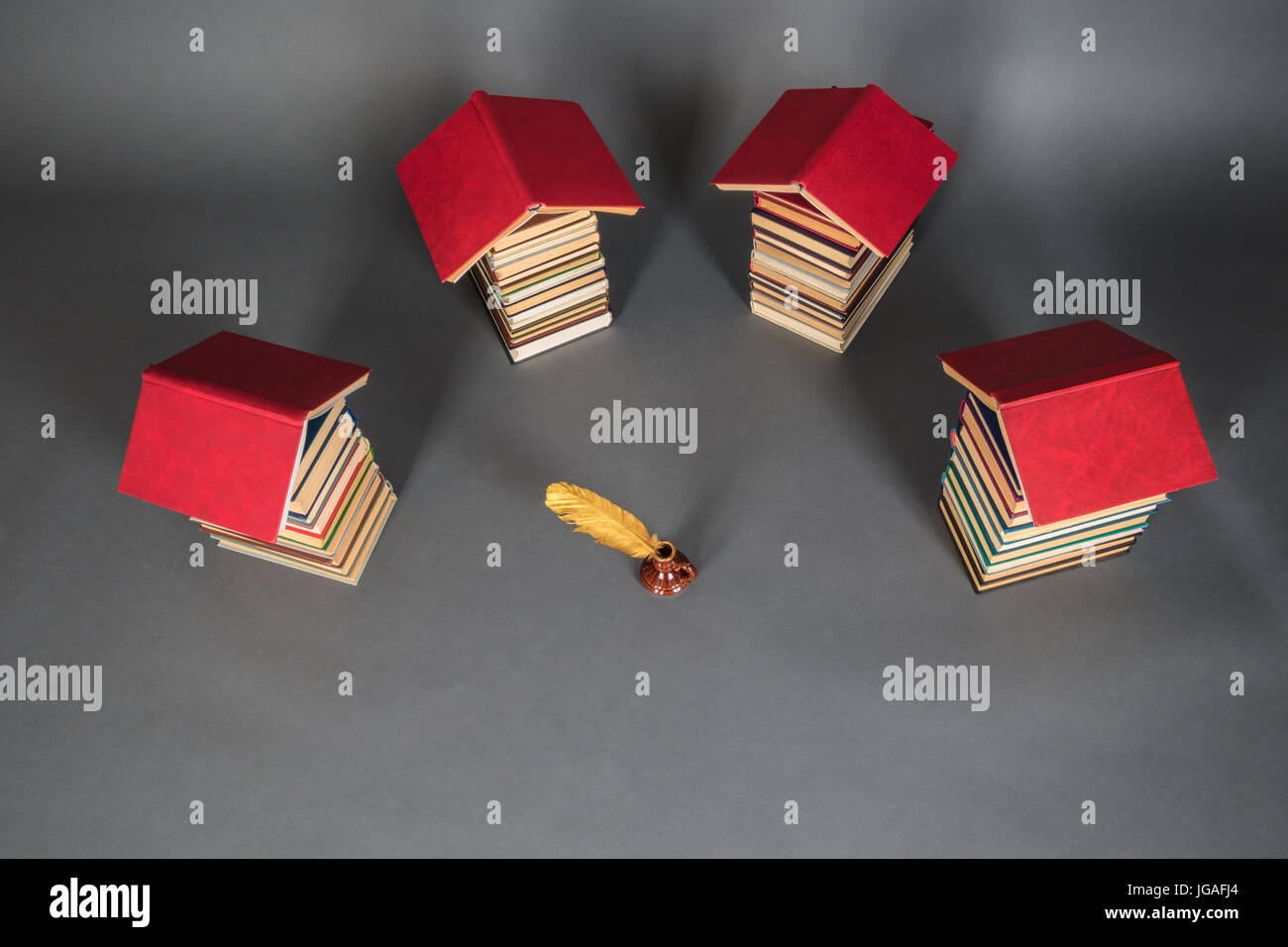 Education reading and writing concept with books and quill pen Stock