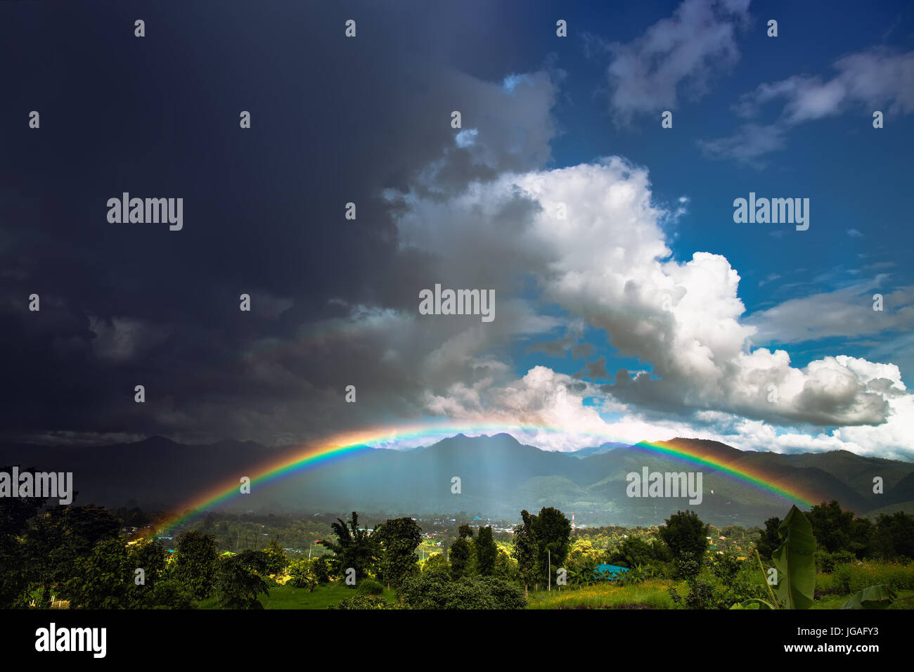 Bright rainbow after the heavy rain. Pai, Thailand. Stock Photo