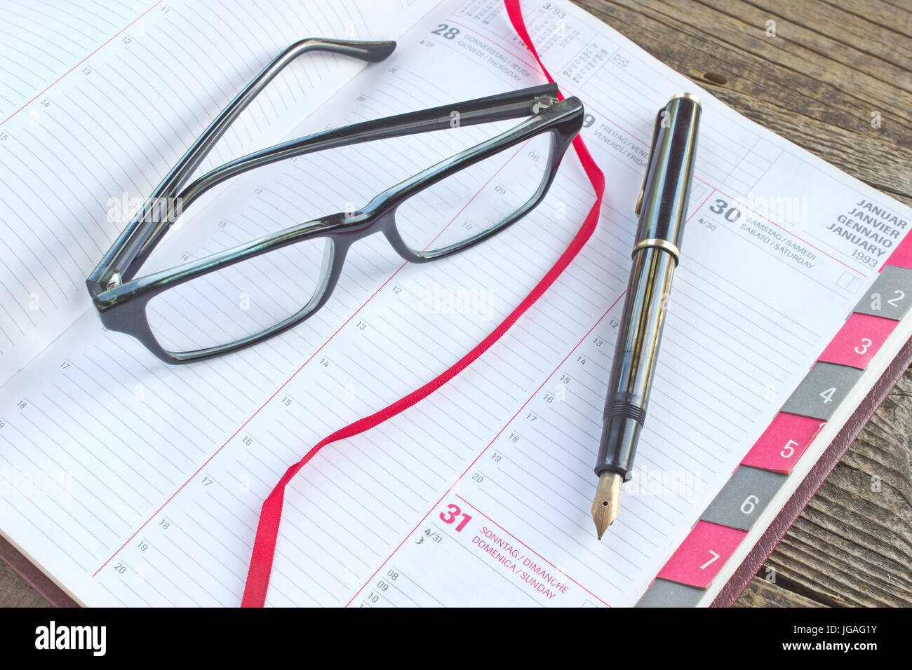 Fountain pen and personal organizer with eyeglasses Stock Photo - Alamy