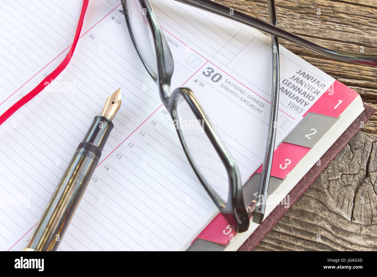 Fountain pen and personal organizer with eyeglasses Stock Photo - Alamy